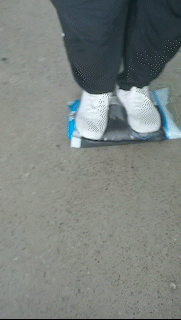 A man steps on a filled bag to show it doesn't rip or blow out. 